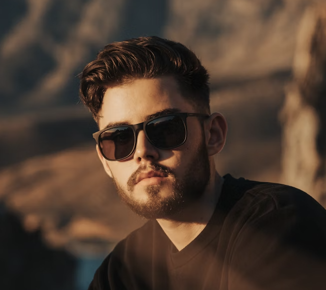 Man with beard and sunglasses in warm sunlight
